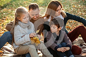 Portrait of happy family in autumn park