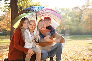 Portrait of happy family in autumn park