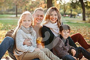 Portrait of happy family in autumn park