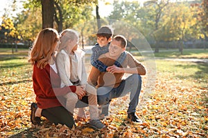 Portrait of happy family in autumn park