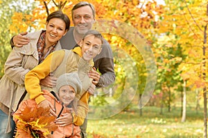 Portrait of happy family in autumn park