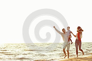 Portrait of happy family and baby enjoying sunset in the summer leisure