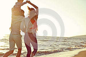 Portrait of happy family and baby enjoying sunset in the summer leisure