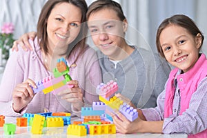 Portrait of happy family collecting colorful blocks photo
