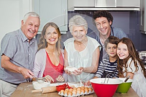 Portrait of happy family cooking food in kitchen
