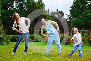 Portrait of happy family doing physical exercise