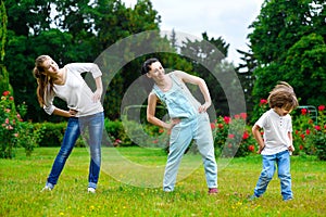 Portrait of happy family doing physical exercise