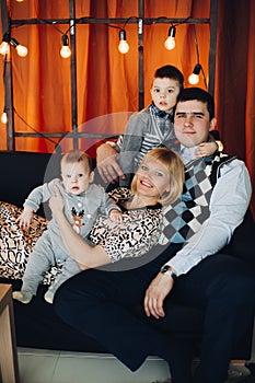 Portrait of happy family embracing in decorated studio.