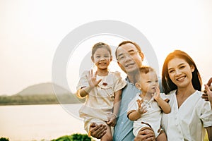 Portrait of happy family enjoying a beautiful spring day in park