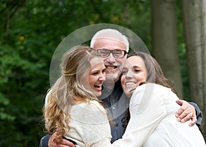 Portrait of a happy family with father and two daughters
