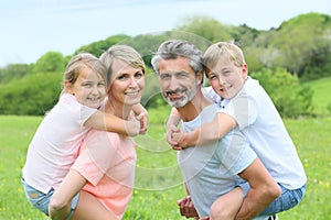 Portrait of happy family in the fields