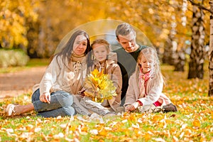 Portrait of happy family of four in autumn day