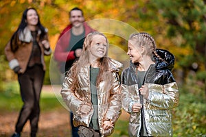 Portrait of happy family of four in autumn day