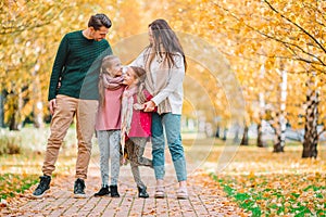 Portrait of happy family of four in autumn day