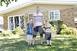 Portrait of happy family in front house