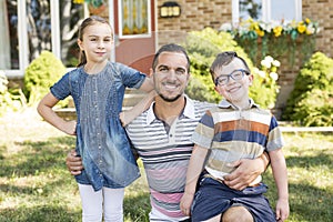 Portrait of happy family in front house