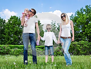 Portrait Of Happy Family In Garden