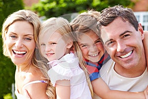 Portrait Of Happy Family In Garden