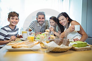 Portrait of happy family having breakfast together