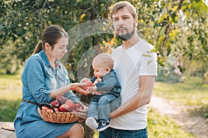 Portrait of Happy family hugging and spending time together outside in green nature