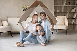 Portrait of happy family with kid celebrate relocation