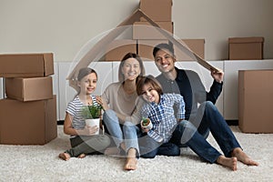 Portrait of happy family with kids in new house