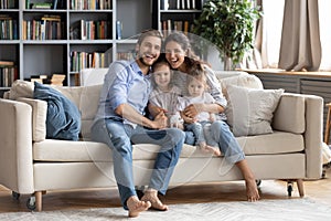 Portrait of happy family with kids relax on couch