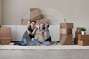 Portrait of happy family with kids relax on moving day