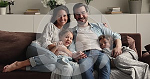 Portrait of happy family with little kids sit on couch