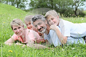 Portrait of happy family lying in grass