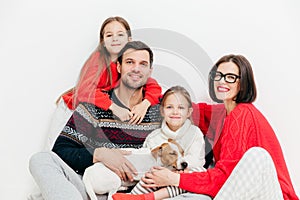 Portrait of happy family members with positive expressions, cuddle and support each other, have good relationship. Delighted