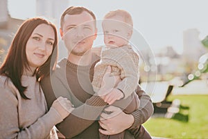 Portrait happy family mom dad and son having fun and enjoying spending time together in autumn park