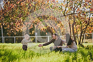 Portrait happy family mom dad and son having fun and enjoying spending time together in autumn park on sunny day