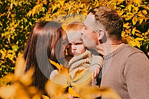 Portrait happy family mom dad and son having fun and enjoying spending time together in autumn park on sunny day