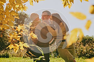 Portrait happy family mom dad and son having fun and enjoying spending time together in autumn park on sunny day