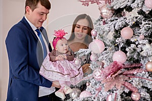 Portrait of happy family near Christmas tree.Family, christmas, winter,happiness and people concept