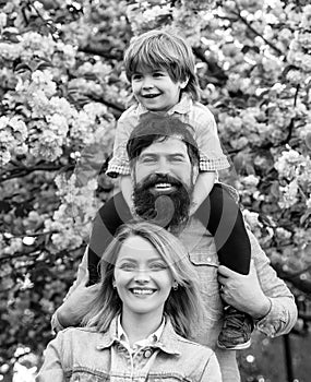 Portrait of Happy family outdoors. Mother, father and son. Young happy family of three having fun together outdoor.