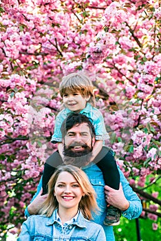 Portrait of Happy family outdoors. Mother, father and son. Young happy family of three having fun together outdoor.