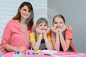 Portrait of a happy family playing board games at a table