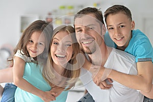 Portrait of happy family posing at home