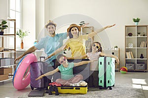 Portrait of happy family ready for holiday trip pretending to fly like a plane at home