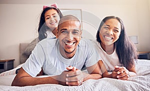 Portrait, happy and a family relax on a bed at home while laughing and playing for quality time. Man, woman or hispanic