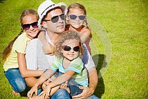 Portrait a happy family sitting on the grass