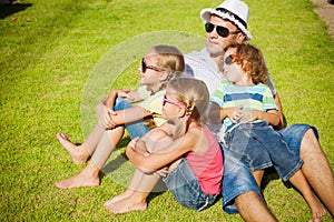 Portrait a happy family sitting on the grass