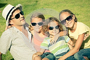 Portrait a happy family sitting on the grass