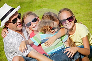 Portrait a happy family sitting on the grass