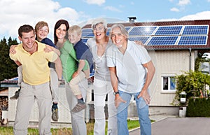 Portrait Of A Happy Family Smiling Outside House