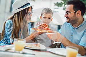 Portrait of happy family spending time in cafe