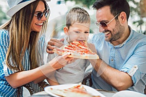 Portrait of happy family spending time in cafe