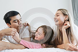 Portrait happy family spending time together on bed in bedroom. family and home concept